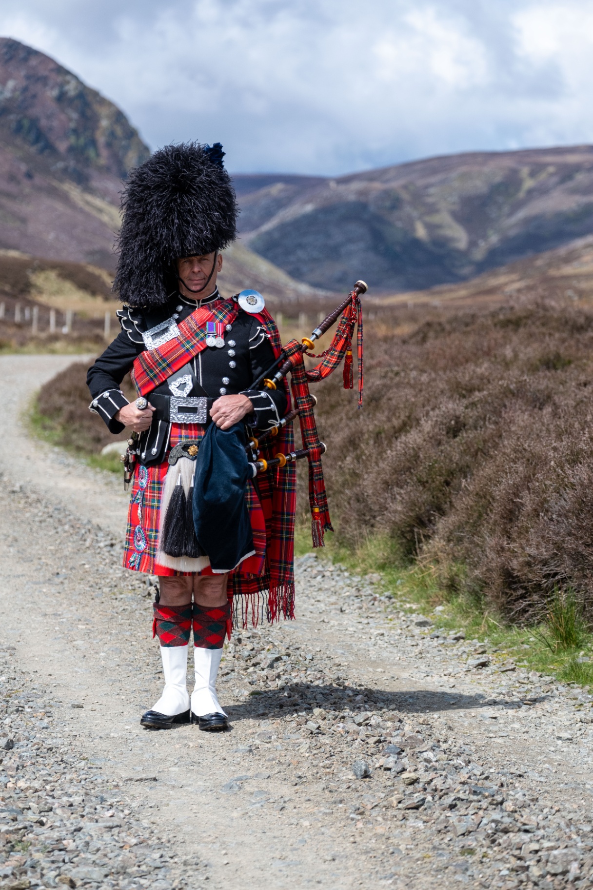 Piper on a Highland track
